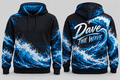 Black hoodie with vibrant blue ocean wave print, front view showing kangaroo pocket and drawstring hood, stylish casual wear